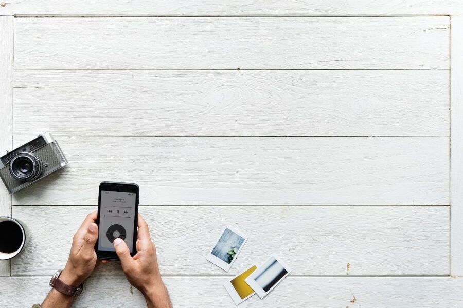 Someone using a phone at a white table