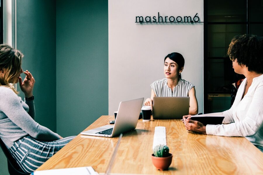 three people holding a meeting