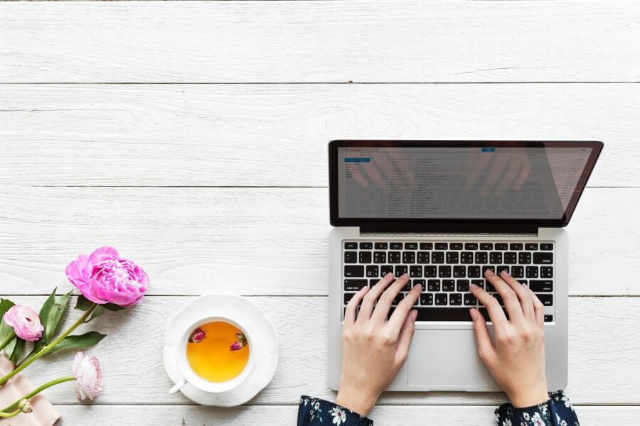 someone typing on a computer at a table