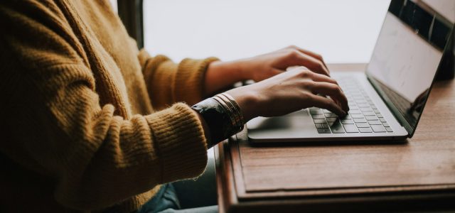 Header image showing person working at their computer