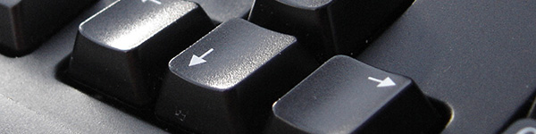 Close up of the Down-Arrow and Right-Arrow keys on a black keyboard