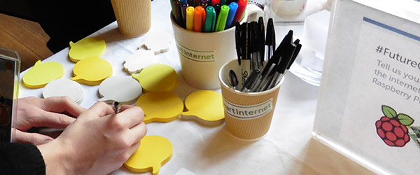 Attendees writing for the Future of the Net wall