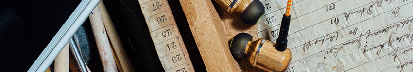 A mobile phone and a pair of earphones on a workshop table