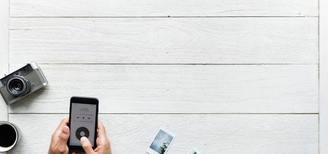 Someone using a phone at a white table