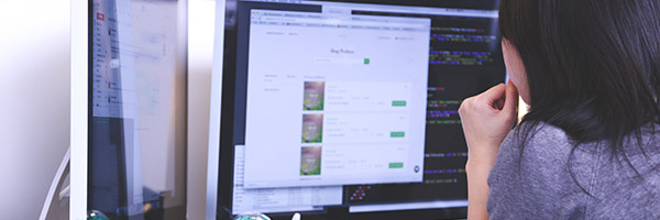 Woman looking at a website and the code behind it