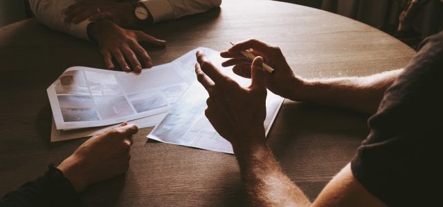 Three people talking at a table